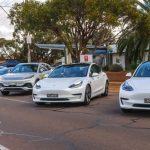 Electric vehicle owners driving their vehicles to Whyalla, allowing people to see and ask about their vehicles.